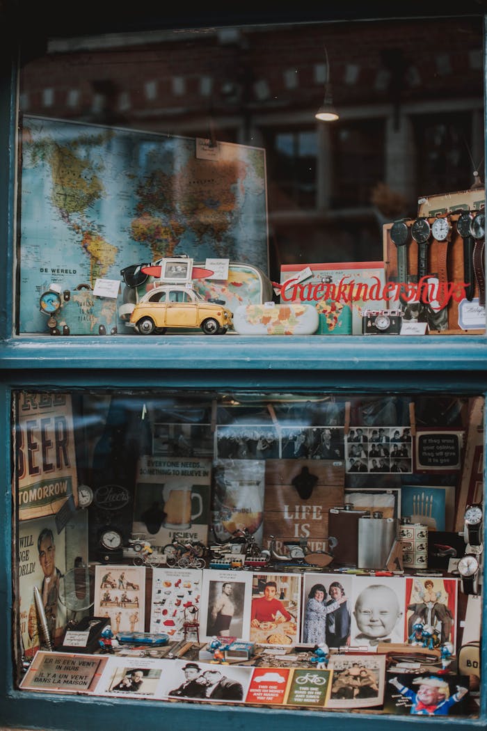 services-02 Charming window showcasing vintage maps, toy cars, and memorabilia in Brussels.